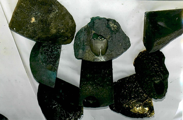 Severely Soot-Contaminated Glass Pieces Prior to Cleaning and Restoration